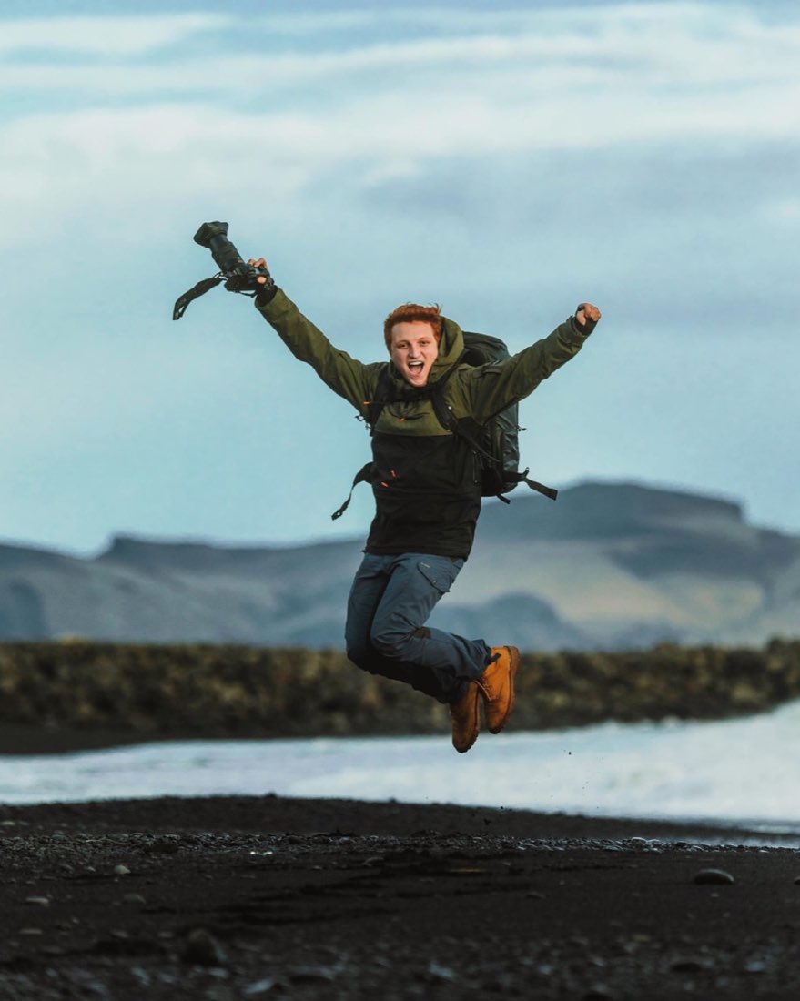 Filippo Dias jumping with a camera in a northern landscape